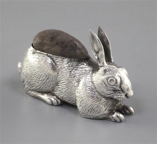 An Edwardian novelty silver pin cushion modelled as a rabbit by Adie & Lovekin, 2.5in.